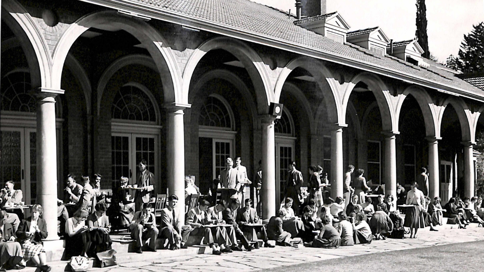 A historical black and white photo of the students sitting in the Adelaide University cloisters