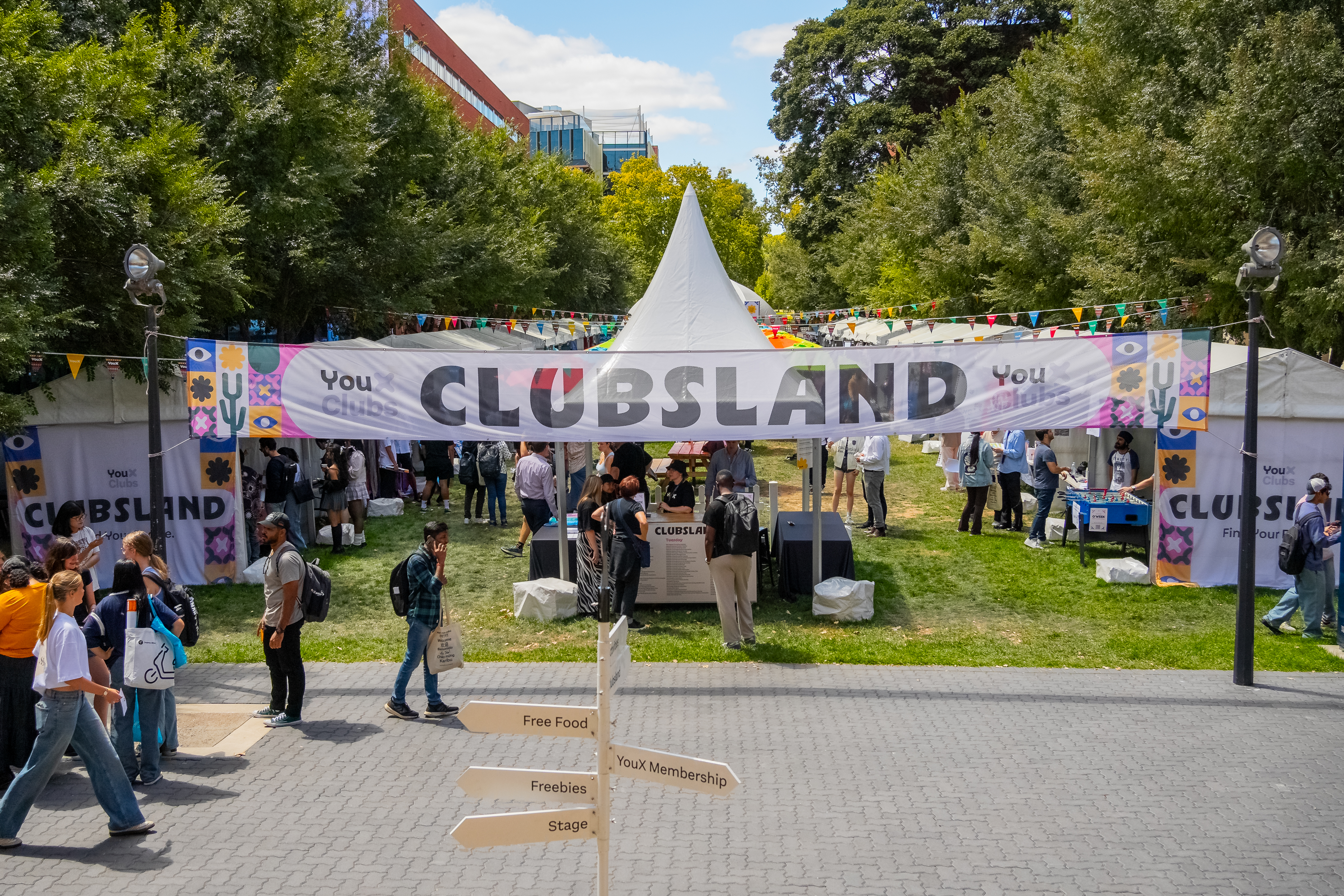 Students look at different club stalls on the Maths Lawns in front of the Barr Smith Library